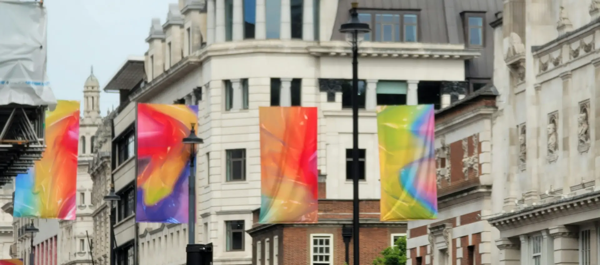 Crowd holding rainbow flags at a Pride parade